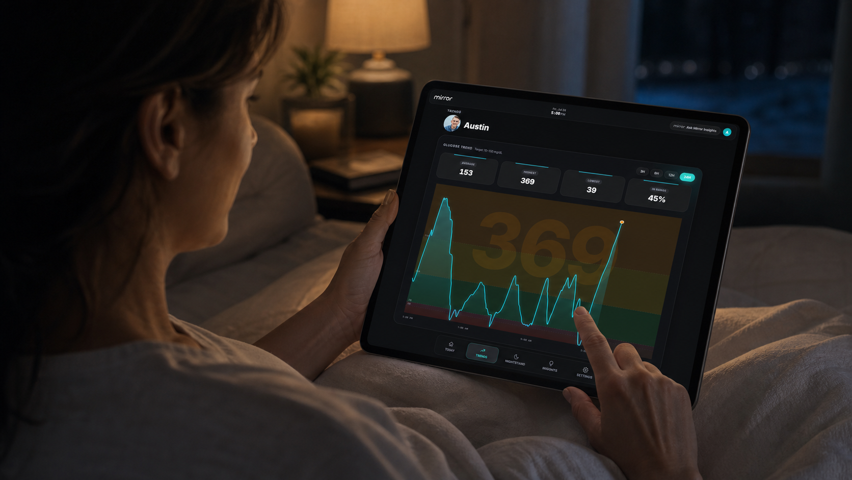 A caregiver reviewing Mirror Health glucose trends during the night