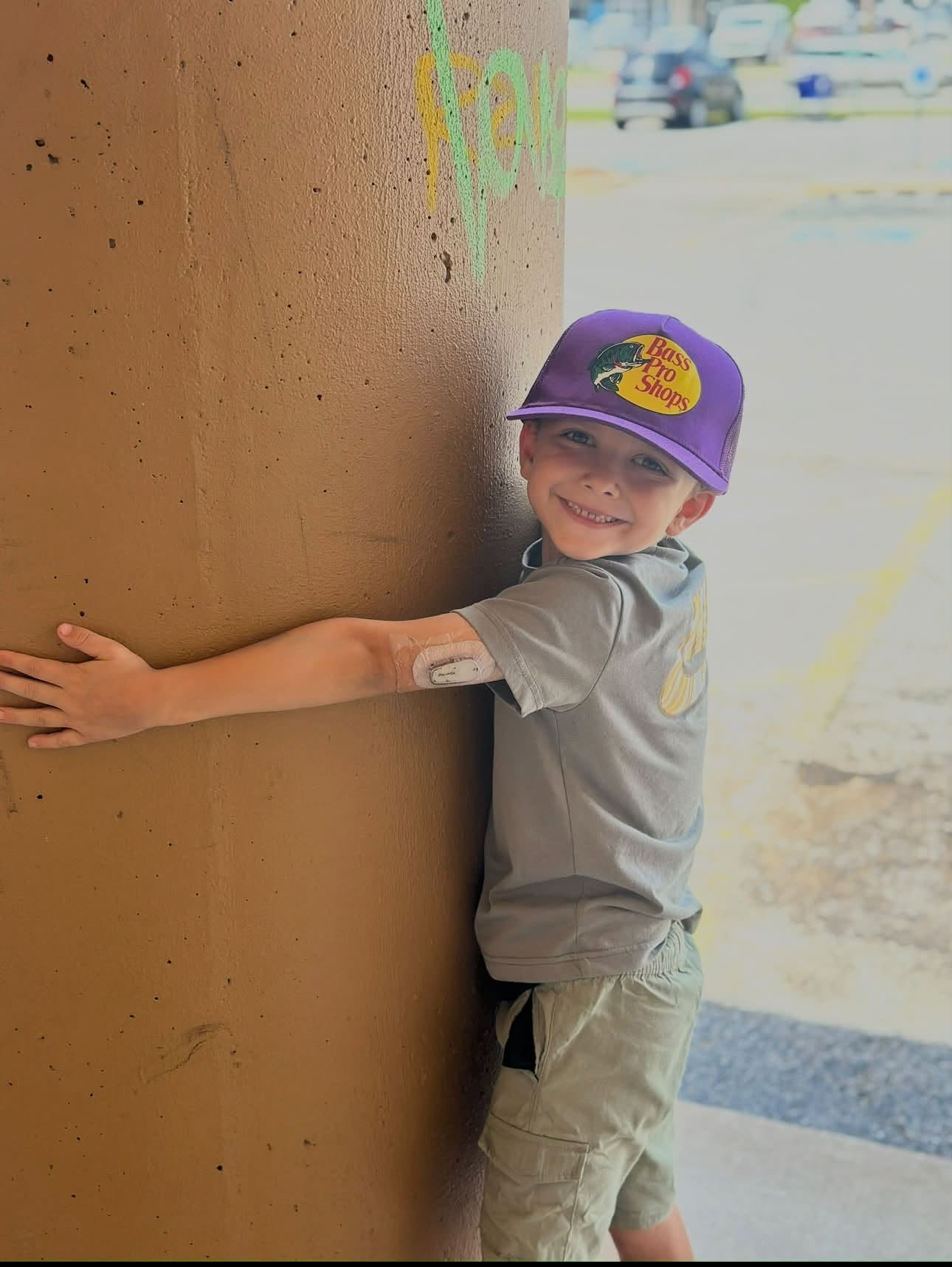 Rylan smiling in his purple cap